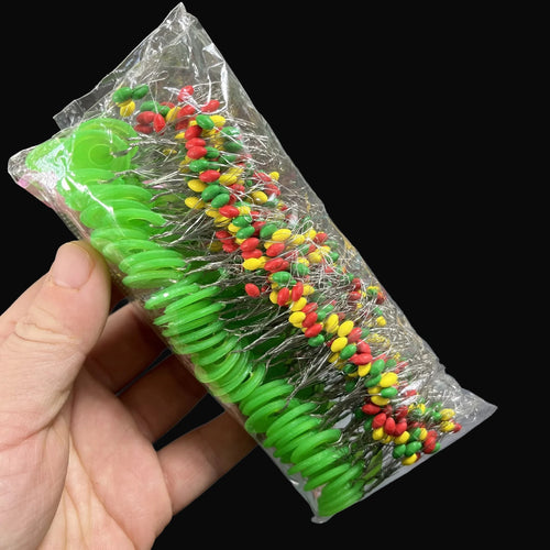 Driftline Rubber Fishing Line Stoppers pack in hand on dark studio background
